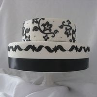 Black & White I did this cake for a local gift store that wanted a display cake for their window. Fondant covered with royal piping.