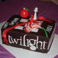 Twilight Cake This is a "Twilight" book cake with all the symbols from each of the four books on it.