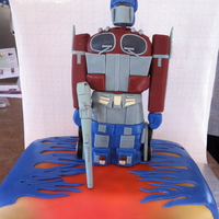 Optimus Prime - Transformers Vanilla base with buttercream icing. Rice cereal Optimus Prime structure. The details are made of fondant, gumpaste and modelling chocolate...