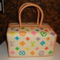 Louis Vuitton Purse Two 1/4 sheet cakes cute in half and stacked. The flavor was Jamaican Rum cake with vanilla buttercream. Covered in MMF and LV logo hand-...