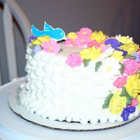 Wilton Class 2 Vanilla Pound, buttercream icing and royal icing flowers. Color flow bird.