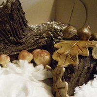 Christmas Yule Log 2010 vanilla sponge with caramel pecan filling chocolate icing and marzipan mushrooms, gumpaste oak leaves and acorns...the snow is cotton candy...