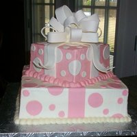 Baby Shower Baby Shower cake made to look like presents. White Cake with White Chocolate Cheesecake filling. Buttercream with fondant accents and...