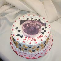 Valentine Pug Photo of Maggie the Pug copied onto frosting sheet. Dog bones and paws decorate the sides. Hearts and paws on top. Triple chocolate cake...