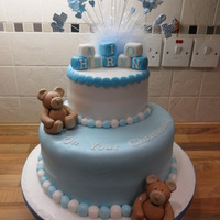 Teddy Bear Christening Cake All the decoration on this cake was made from fondant.The bottom layer is rich chocolate sponge filled with chocolate fudge filling.The top...