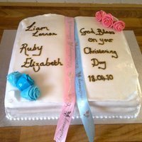 Bible Christening Cake This cake was made for my neice and nephews christening!! It is an open bible, with handmade roses in the corner, it was for a boy and girl...