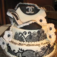 Chanel Purse And Shoe Birthday Cake! Black detail made with a tip 1 and royal icing, cakes covered in mmf, the purse is made out of cereal treats covered in mmf, the flowers...