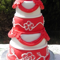 Red & White This cake was a few firsts for me. First time doing drapes & brush embroidery. Bottom & top tiers are Port Wine Mud Cake & the...