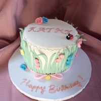 Spring Birthday Cake Small 6" white cake with raspberry filling and and white buttercream. All fondant decorations.