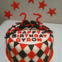 Black And Red 8" Round Birthday Cake made with Chocolate Fudge Cake and Buttercream Icing. 8" round 2 layer. Dazzled with Fondant decor.