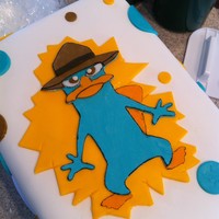 Agent P! Perry the Platypus from Phineas and Ferb. Carrot cake, cream cheese filling/frosting, cover in MMF.