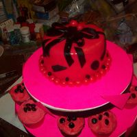First Fondant Cake made this last Saturday; neon pink & black fondant, chocolate cake w/chocolate buttercream icing, strawberry/lemon flavored cupcakes...