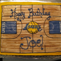 La Lakers Birthday Cake This sheet cake is half white/half orange, covered in buttercream with mmf basketball court.