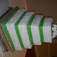 Wedding Cake All buttercream with green fondant ribbon to match bridesmaids dresses. Flowers are gumpaste that I bought. Don't have the patience...
