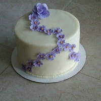 Purple Flowers I was playing around with gumpaste for the first time. Fairly happy with the results. Cake is chocolate chip with chocolate cream filling....