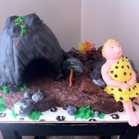 "prehistoric But Not Dead" This was made for a church member's 40th birthday-the caveman is a cartoonish version of him. The cave is all cake as is the base...
