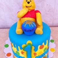 Winnie The Pooh Birthday Winnie is made of RKT and the cake was a white cake with a white chocolate ganache buttercream frosting and a white chocolate bavarian...