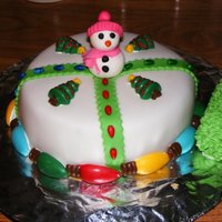 Snowman Christmas Cake MMF covered. Christmas lights made from chocolate. Everything edible. Cake was chocolate with peanut butter filling.