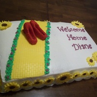 Coming Home Basic sheet cake; modeling chocolate decoations. Kansas themed with a yellow brick road and red slippers and sunflowers