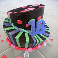 Wonky And Wacky Colours This 18th birthday cake was made for a young lady who loved chocolate and bright colours. I couldn't resist dressing up the cake...