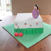 Japanese Cherry Cake This is a Japanese cherry cake. Figurine on top made from fondant and cherry piped on the sides.