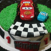 Cars Birthday Cake 2 layer vanilla cake with chocolate cream in the centre. Cars made of sugarpaste and used buttercream for the grass.