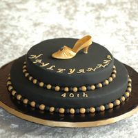 Black And Gold A 40th birthday cake for a friend's Black Tie and Tiara party. Chocolate devil's food cake on the bottom and milk choc sponge on...