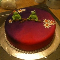Froggy Frogs are fondant. Airbrushed pink and purple and put white sixlets around the base