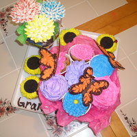 Cupcake Flower Bouquet With Butterflies This was for my grandmothers birthday. They are Vanilla bean cupcakes with a strawberry filling and buttercream. The main flower bouquet is...