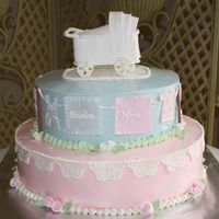 Twins Baby Shower IMBC; gumpaste clothes, lace/eyelet pieces, and ribbon roses; pastillage baby carriage. Special thanks to melvin01 for the detailed...