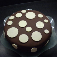 Chocoate Circles orange chocolate cake with rolled chocolate fondant, with white chocolate circles.