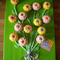 Moms Bouquet cupcakes made into flowers, with fondant for stems. Flower petals are mini marshmallows cut in half and pinched at either end.