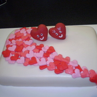 Cascading Hearts lemon cake with raspberry filling, rolled BC covered with rolled BC hearts. 2 hearts on top made from fondant.