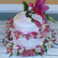 Mini Wedding Cake I made this for a friends sister who had a small wedding on the beach. The flowers are real, it was a yellow cake covered in fondant with...