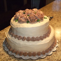 2 Tier Cake my first attempt at a 2 tier cake and at the wilton roses. i need to work on leveling my cakes more, but overall i'm pretty pleased!