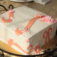 Pink/coral Flower Birthday Cake White cake with Strawberry Cream filling and buttercream icing.Gumpaste flowers and decorations.