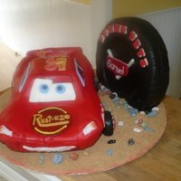 Lightning Mcqueen Car Cake Lightning McQueen car and tire on a sandy road