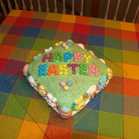 Easter Cake This Easter cake is covered in buttercream frosting with jellybeans, marshmallows, colored sugar and Reese's eggs for decorations. The...