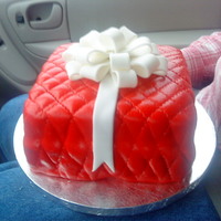 Christmas Present This is the first square cake I've made it was lemon cake with a lemon filling. Covered in fondant and quilted, bow was 50/50 mix.