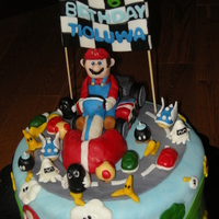 Mario Kart Wii Cake All characters are made of fondant/modelling chocolate/gumpaste. Mario and his kart are made of cereal treats.