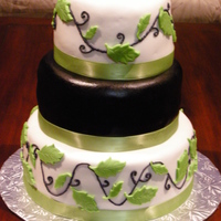 Wedding Cake 3 Tiered wedding cake. Middle layer is chocolate fondant colored in black.
