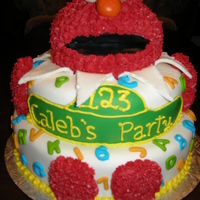 Elmo All edible chocolate cake. 3 tiers. Covered with buttercream and MMF. Head is piped with buttercream.
