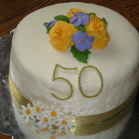 50Th Wedding Anniversary Flowers are made of gumpaste. 50 is made of fondant and gold beads on top.
