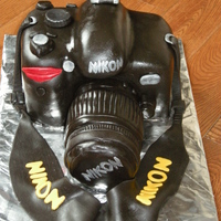 Nikon Camera Chocolate cake, covered in vanilla buttercream, topped with chocolate covered fondant tinted black.