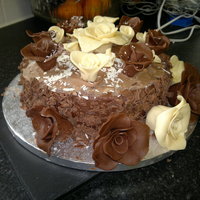 Bailey's Chocolate Truffle Cake The cake has bailey's chocolate truffles melted into the mix. Covered in milk chocolate ganache and melted white chocolate. The roses...