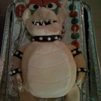 Bowser Cake Super Mario Bowser character cake was made by my mother in law for my sons 6th birthday. The arms and legs are fondant icing. My son was...