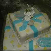 Christening Cake Chocolate cakes covered with rolled sugar paste. Yellow hearts was cut out of sugar paste and crosses was piped on with silver royal icing...