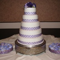 Lavender Cake With Dots And Cupcakes All buttercream, bride's ribbon and flowers.