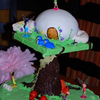 Tinkerbell's House Birthday cake for my twins. Had a horrible time controlling the humidity in my home that day and it wrecked havoc on everything. Very...