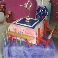 Gymnastics Cake I made the bars and beam from dowel rods and fondant. There is also an awards stand you cannot see in the pic. the girl on top, on the...